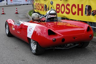 A red open-top racing car with a driver in full gear, SOLITUDE REVIVAL 2011, Stuttgart,