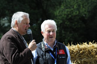 Two men conducting an interview at a car race, surrounded by spectators, SOLITUDE REVIVAL 2011,