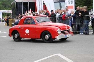 Red vintage car drives past a crowd at a racing event, SOLITUDE REVIVAL 2011, Stuttgart,