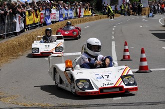Racers concentrate on the race in white soapboxes in front of a crowd, SOLITUDE REVIVAL 2011,