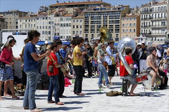 Music group playing on the street in Marseille, surrounded by spectators, Marseille, Departement