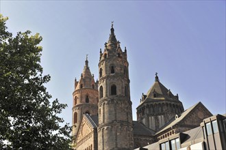 Speyer Cathedral, View of a church cathedral with detailed towers in front of a blue sky and urban