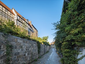 Narrow alley with half-timbered houses and cobblestones on the Schlossberg in the historic old