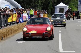 A Porsche 911 drives past a crowd at a car race, SOLITUDE REVIVAL 2011, Stuttgart,