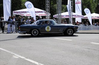 A dark blue Lancia vintage coupe on a race track in front of an audience, SOLITUDE REVIVAL 2011,