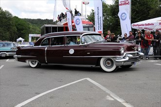 Burgundy red Cadillac classic car drives past a crowd at an event, SOLITUDE REVIVAL 2011,