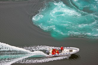 Powerboat with passengers between tidal eddies in the sea, Saltstraumen, Bodoe, Nordland, Norway,