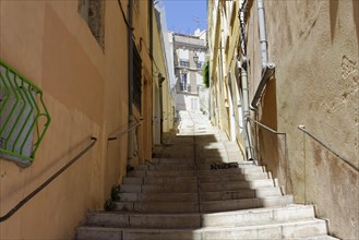 Marseille, Narrow alley with stairs between old buildings on a sunny day, Marseille, Departement