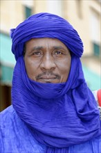 Businessman from Morocco, Mistrustful look of a man in a blue turban in an urban environment,