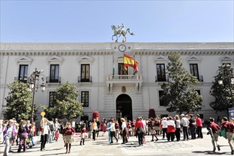 Granada, People gather in front of the town hall with statues and waving flags, Granada, Andalusia,
