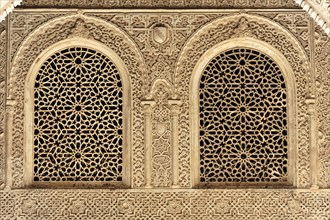Artistic stone carvings, Alhambra, Granada, Two windows with ornate Islamic carvings in a stone