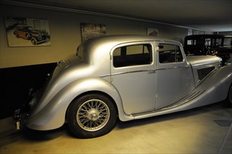 Deutsches Automuseum Langenburg, A grey classic car in a garage, radiating elegance and history,