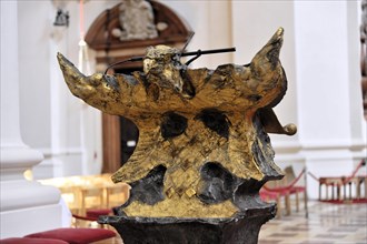 St Stephan's Cathedral, Passau, Abstract gold-coloured sculpture as a modern art accent in a