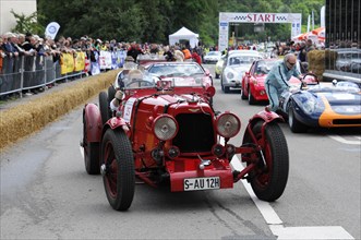 A red vintage racing car at an event surrounded by spectators, SOLITUDE REVIVAL 2011, Stuttgart,