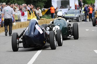 Two classic racing cars competing on a track with an audience, SOLITUDE REVIVAL 2011, Stuttgart,