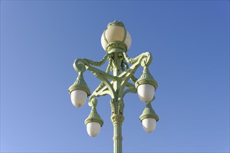 Marseille, An ornate green street lamp with five lights against a clear blue sky, Marseille,