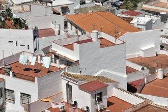 Solabrena, aerial view of a town with white buildings and terracotta roofs, laundry hanging
