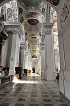 St Stephan Cathedral, Passau, Elongated interior of a church with columns and rays of light falling