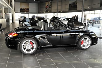 A black Porsche Boxster with red brake callipers presented at the dealership, Schwaebisch Gmuend,