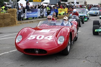 A red classic racing car with starting number 504 drives past spectators, SOLITUDE REVIVAL 2011,