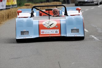 Close-up of a blue and white open-top racing car with the driver in a helmet, SOLITUDE REVIVAL