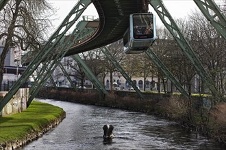 Suspension railway and sculpture by Bernd Bergkemper in the river Wupper commemorating the jump of