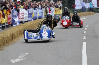 Racing motorbike with sidecar at full speed, rider in racing position, SOLITUDE REVIVAL 2011,