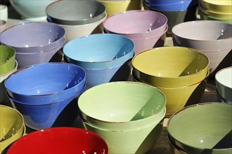 Pottery bowls, pots, colourful stacked clay bowls at an outdoor market, Marseille, Departement