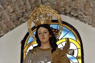 Castillo de Santa Catalina in Jaen, A statue of a crowned saint with a palm branch in a church,