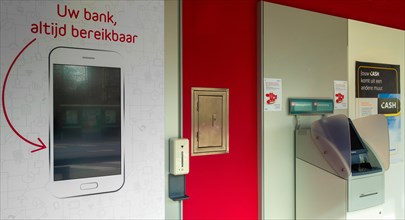 Indoor ATM cash dispenser, cashpoint of Belfius bank office in village, East Flanders, Belgium,