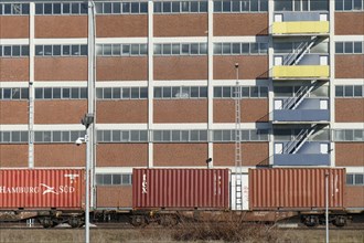 Harbour shed with container train in Bremen's Ueberseestadt district, Bremen, Germany, Europe