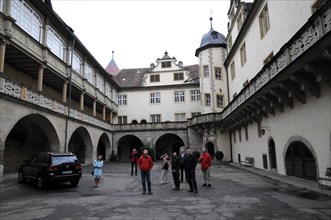 Langenburg Castle, People in the courtyard of a historic building with arched structures and a
