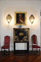 Langenburg Castle, Classic interior with portrait painting and candlesticks on the wall and two red