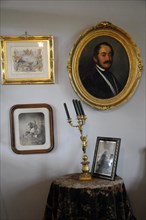 Langenburg Castle, wall with paintings, photos and candlesticks in historical style, Langenburg