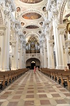 St Stephan Cathedral, Passau, Long view through the nave with organ in the background and visitors