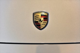 Close-up of the metallic Porsche emblem on a car, Schwaebisch Gmuend, Baden-Wuerttemberg, Germany,