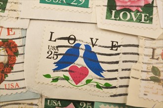 Close-up of old USA twenty five cent postage stamps with pair of blue doves, a red heart and green
