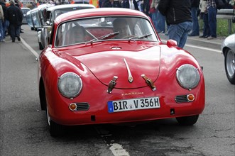 Red classic Porsche on a street, surrounded by people at an event, SOLITUDE REVIVAL 2011,
