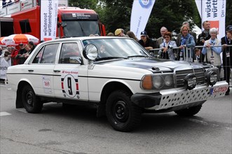 A white vintage rally car with the number 9 drives in front of the spectators, SOLITUDE REVIVAL
