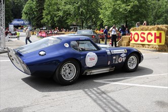 A blue historic racing car with starting number on a race track in front of spectators, SOLITUDE