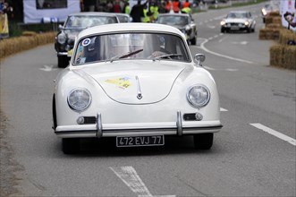 A white Porsche classic car drives past spectators at a race, SOLITUDE REVIVAL 2011, Stuttgart,