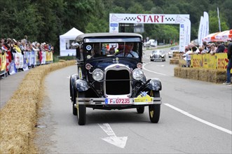 Ford Model A, year of construction 1929, Black Ford classic car in front of the starting line of a