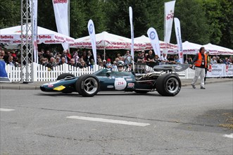 A green formula racing car on a race track driven by a driver, SOLITUDE REVIVAL 2011, Stuttgart,