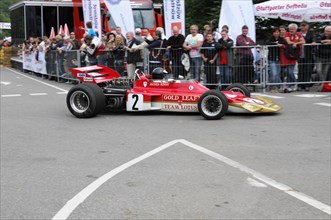 A red formula racing car from Gold Leaf Team Lotus bears the number 2, SOLITUDE REVIVAL 2011,