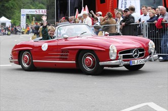Driver of a red Mercedes convertible waving during a racing event, SOLITUDE REVIVAL 2011,