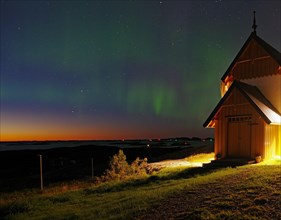 Northern lights (aurora borealis) merging with sunset, Petter Dass Chapel, night shot, Lovunden,