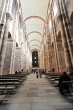 Speyer Cathedral, interior view of a church with pews and columns, soft light falls through the