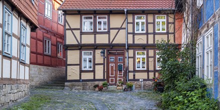 Narrow alley with half-timbered houses and cobblestones in the historic old town, Halberstadt,