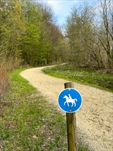 Sign for riders in front of designated signposted bridle path with soft sandy ground leading