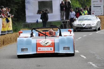 A blue and white open-top racing car with the driver in a helmet on a race track, SOLITUDE REVIVAL